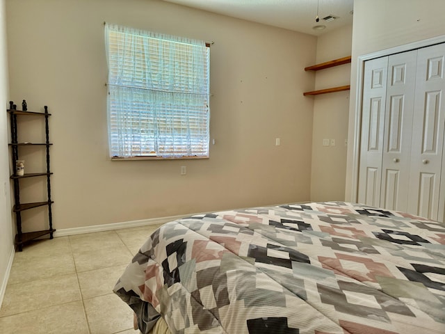 tiled bedroom featuring a closet