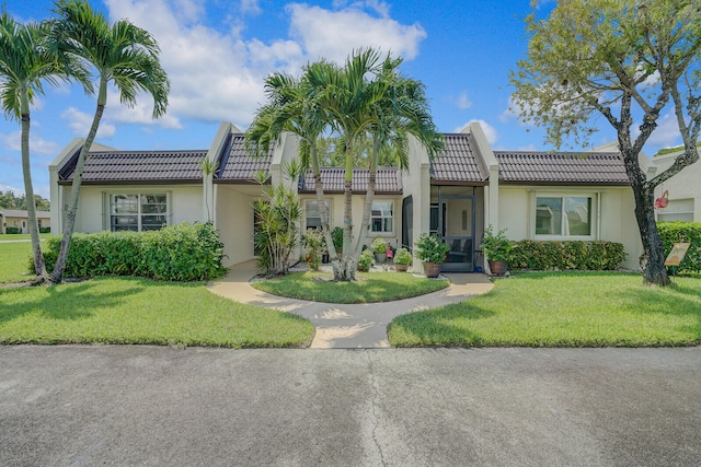 mediterranean / spanish house featuring a front yard