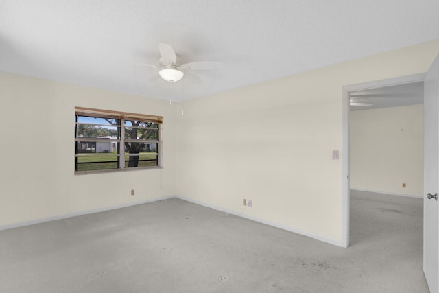 empty room with a textured ceiling, ceiling fan, and light colored carpet