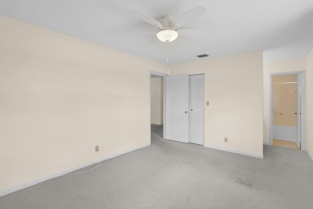 unfurnished bedroom with ceiling fan and a closet