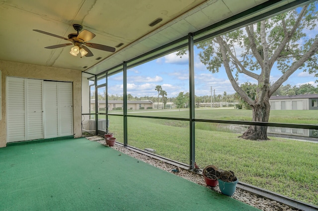 unfurnished sunroom featuring ceiling fan