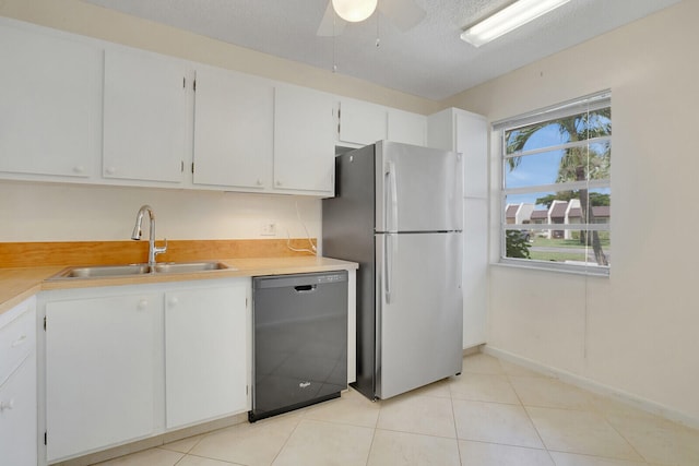 kitchen featuring ceiling fan, stainless steel fridge, sink, white cabinetry, and black dishwasher