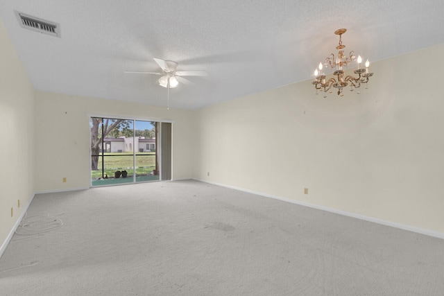 spare room featuring ceiling fan with notable chandelier, a textured ceiling, and carpet floors