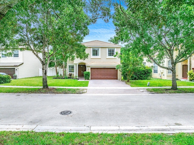 view of front facade with a garage and a front lawn