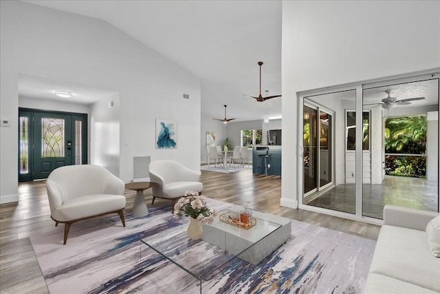 living room featuring high vaulted ceiling, ceiling fan, and hardwood / wood-style floors