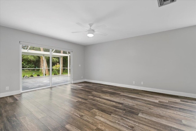 empty room featuring dark wood-type flooring and ceiling fan