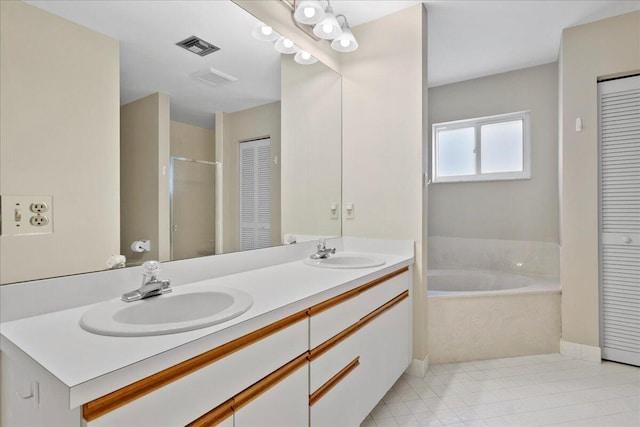 bathroom with tile patterned floors, vanity, and plus walk in shower