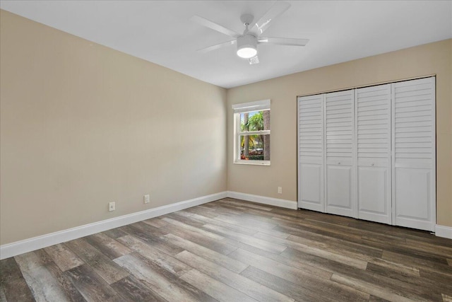 unfurnished bedroom featuring ceiling fan, a closet, and wood-type flooring