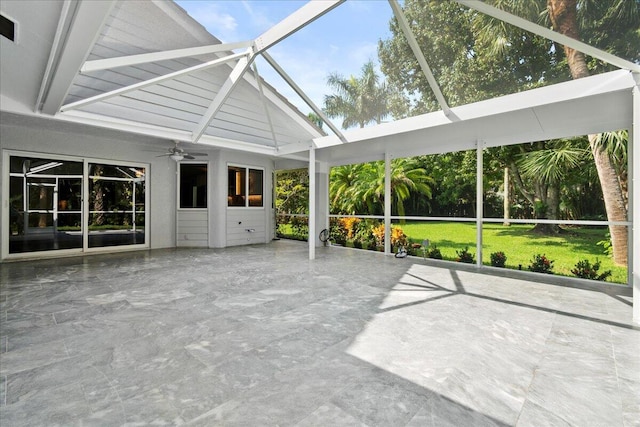 unfurnished sunroom with lofted ceiling with beams and ceiling fan