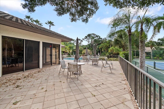 view of patio featuring a sunroom