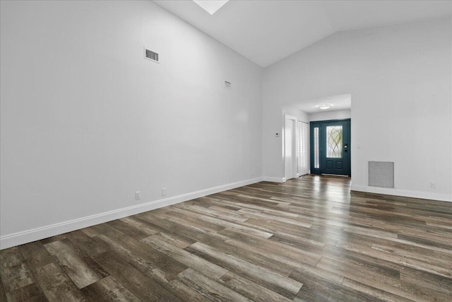 entrance foyer with hardwood / wood-style flooring and high vaulted ceiling