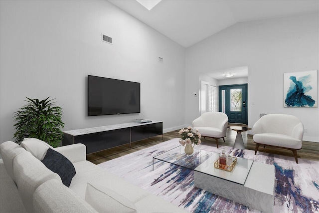 living room featuring hardwood / wood-style flooring and high vaulted ceiling