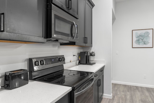 kitchen with light hardwood / wood-style floors and electric range