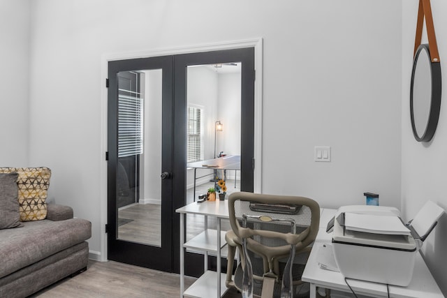 office area with light hardwood / wood-style flooring and french doors