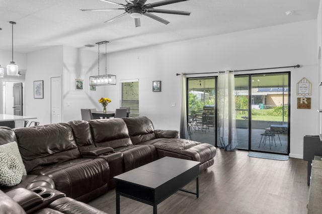 living room featuring wood-type flooring and ceiling fan with notable chandelier