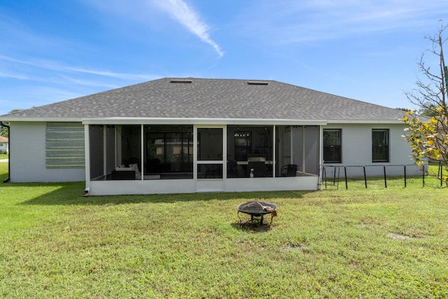 rear view of house with a sunroom and a lawn