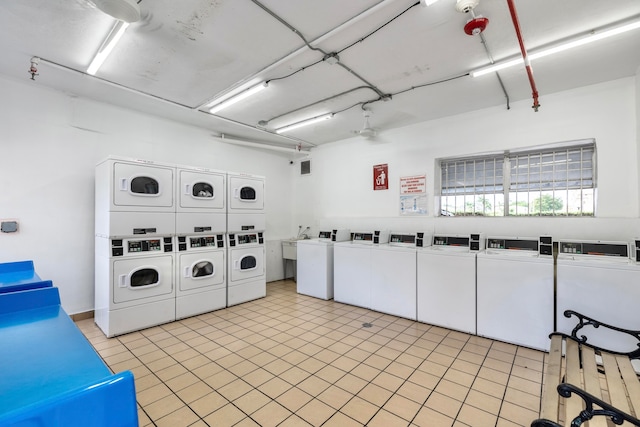 clothes washing area with stacked washer and clothes dryer and washing machine and clothes dryer