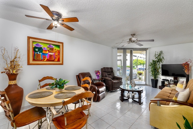 dining area featuring a textured ceiling, light tile patterned floors, and ceiling fan