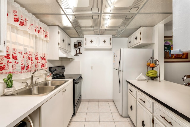 kitchen with black range with electric cooktop, light tile patterned flooring, white fridge, sink, and white cabinets