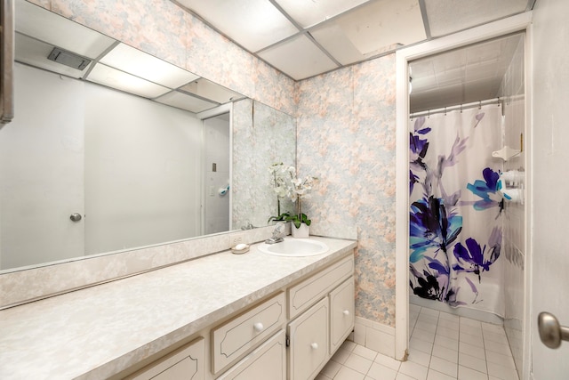 bathroom with a paneled ceiling, tile patterned floors, vanity, and a shower with shower curtain