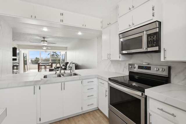 kitchen featuring sink, white cabinetry, and stainless steel appliances