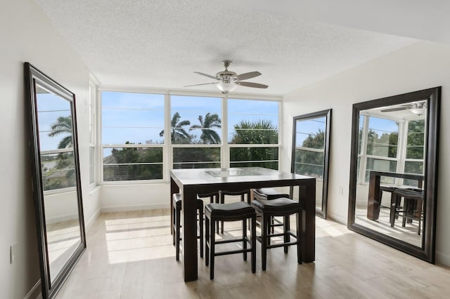 sunroom / solarium featuring ceiling fan