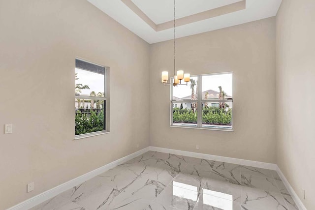 unfurnished dining area with a healthy amount of sunlight and a chandelier