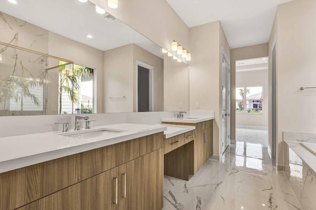 bathroom with vanity and independent shower and bath