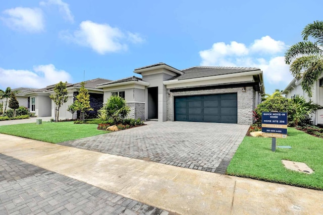 view of front of home featuring a front yard and a garage