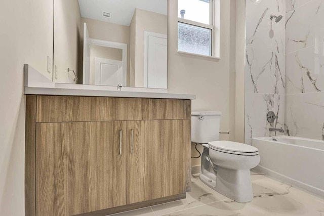 full bathroom featuring vanity, toilet, and tiled shower / bath