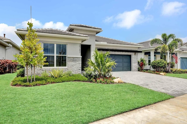 prairie-style house with a front yard and a garage