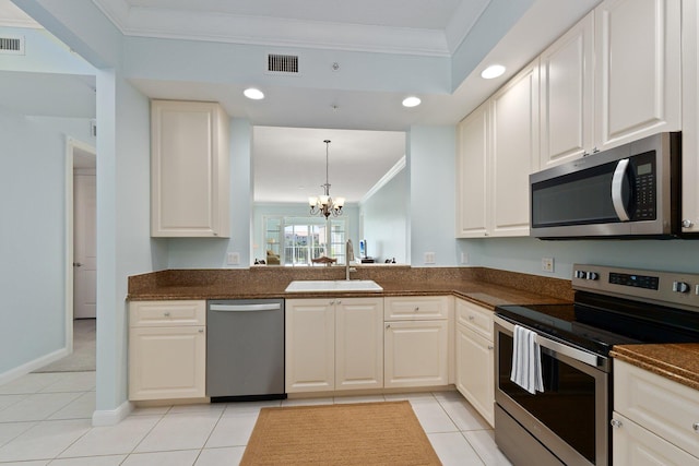 kitchen with white cabinetry, stainless steel appliances, crown molding, sink, and a chandelier