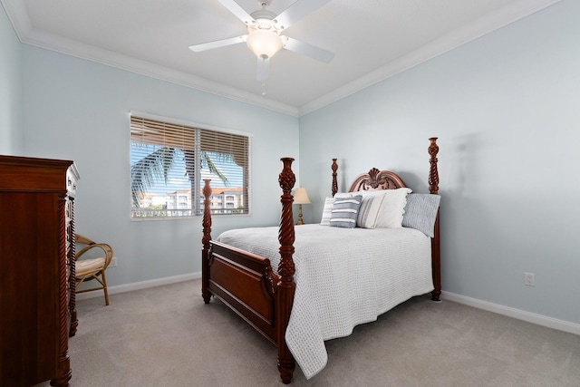 carpeted bedroom with ornamental molding and ceiling fan