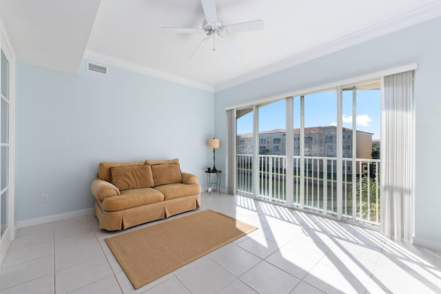 tiled living room with ornamental molding and ceiling fan