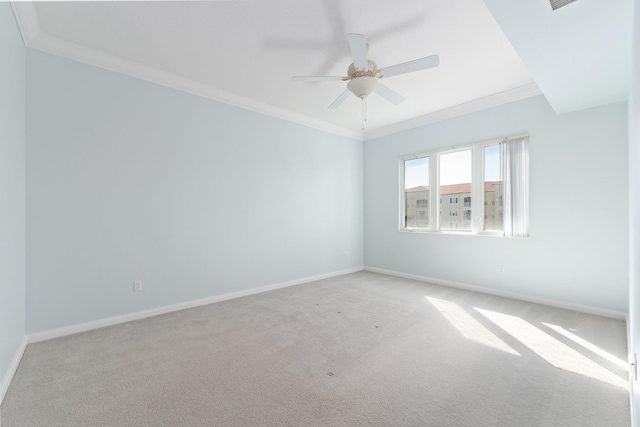 carpeted spare room with ornamental molding and ceiling fan