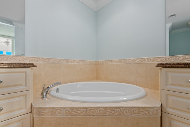 bathroom featuring vanity, a relaxing tiled tub, and crown molding