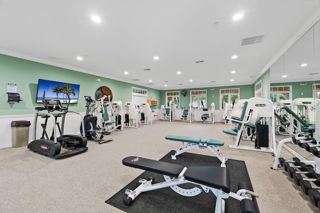 workout area featuring crown molding