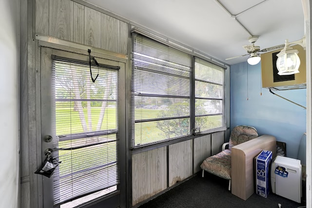 sunroom / solarium featuring ceiling fan