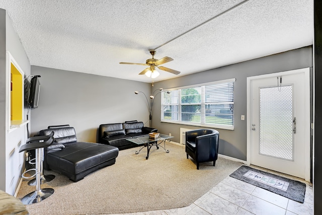 carpeted living room with a textured ceiling and ceiling fan