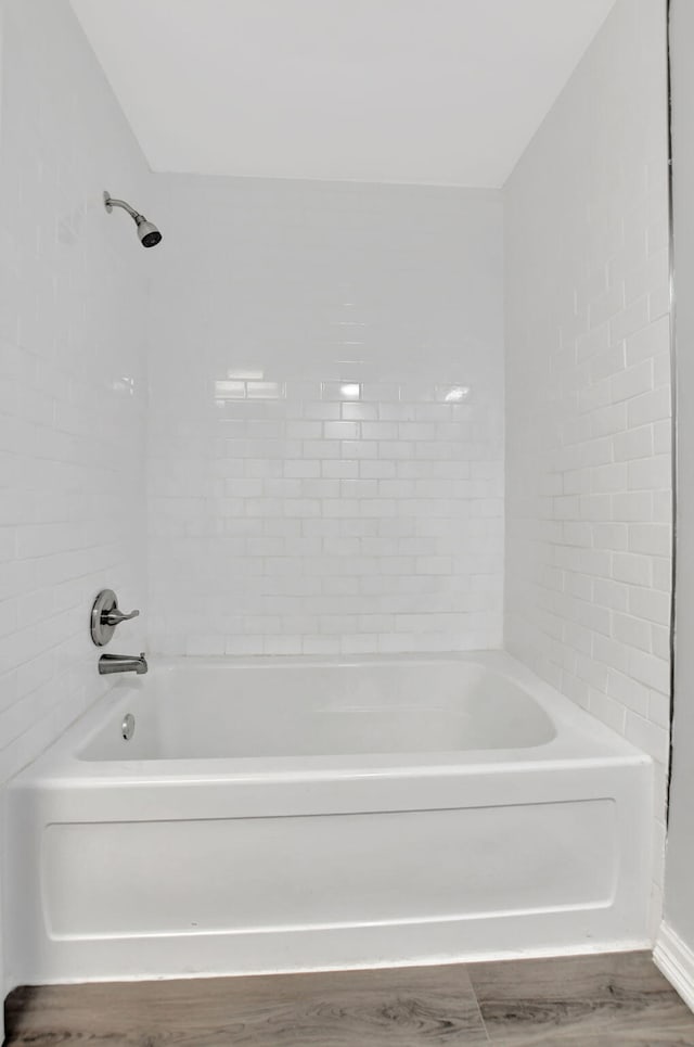 bathroom featuring hardwood / wood-style floors and tiled shower / bath