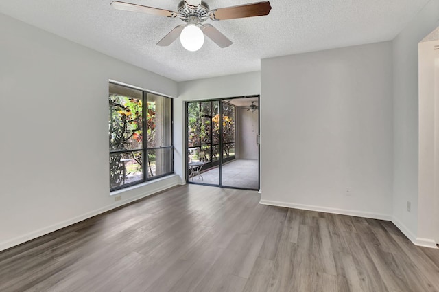 unfurnished room with light hardwood / wood-style flooring, ceiling fan, and a textured ceiling