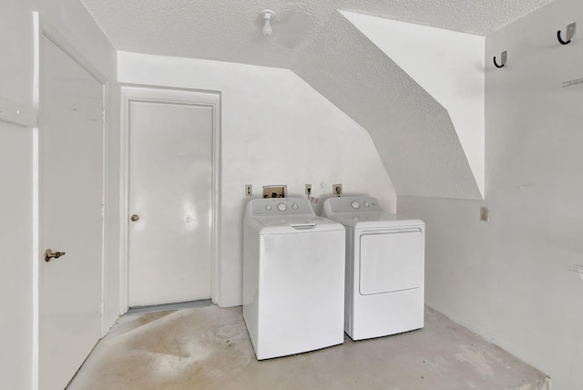 clothes washing area featuring a textured ceiling and washing machine and dryer