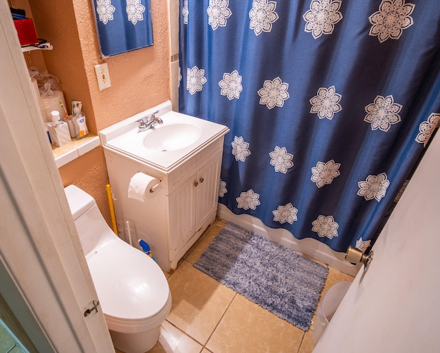 bathroom with curtained shower, vanity, toilet, and tile patterned floors