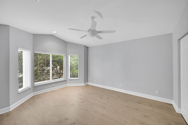 unfurnished room featuring lofted ceiling, light hardwood / wood-style floors, and ceiling fan