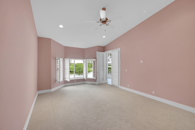 carpeted spare room featuring high vaulted ceiling and ceiling fan