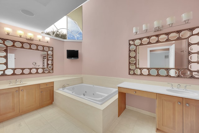 bathroom featuring tile patterned floors, tiled tub, and vanity