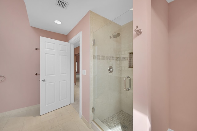 bathroom featuring tile patterned floors and a shower with shower door