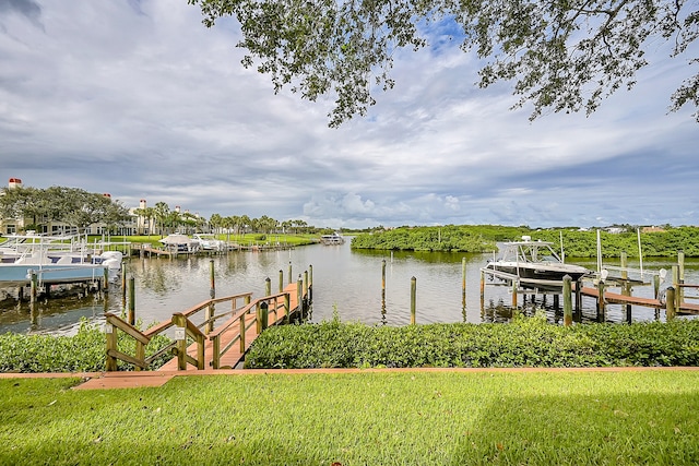 view of dock featuring a water view and a lawn