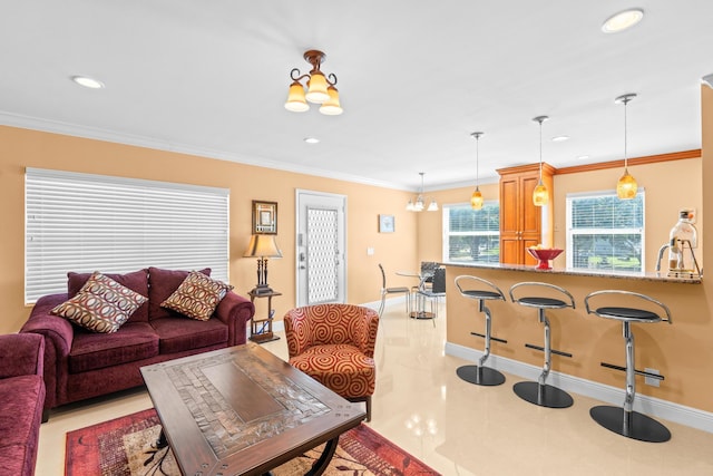 living room with crown molding, sink, light tile patterned floors, and a notable chandelier