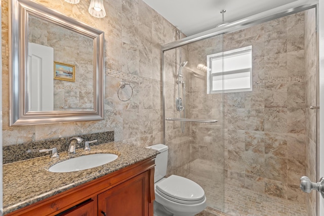 bathroom featuring vanity, an enclosed shower, tasteful backsplash, tile walls, and toilet